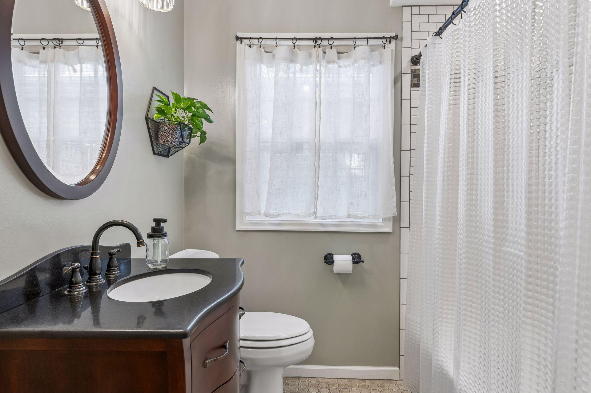 Full bathroom on the main level with tiled shower/bath