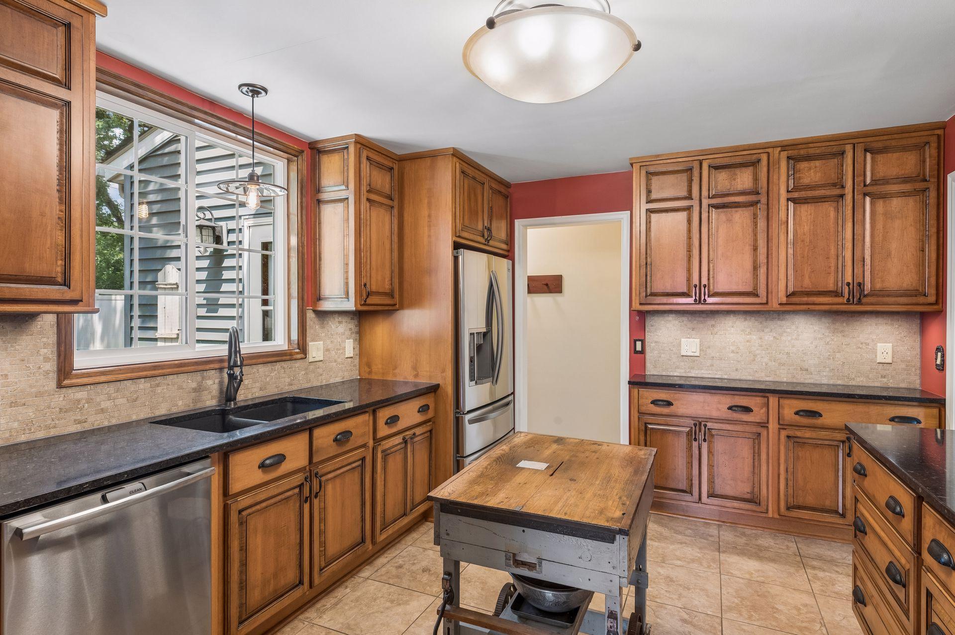 A true heart of the home with a remodeled kitchen with custom cabinets, stainless steel appliances and undercabinet lighting