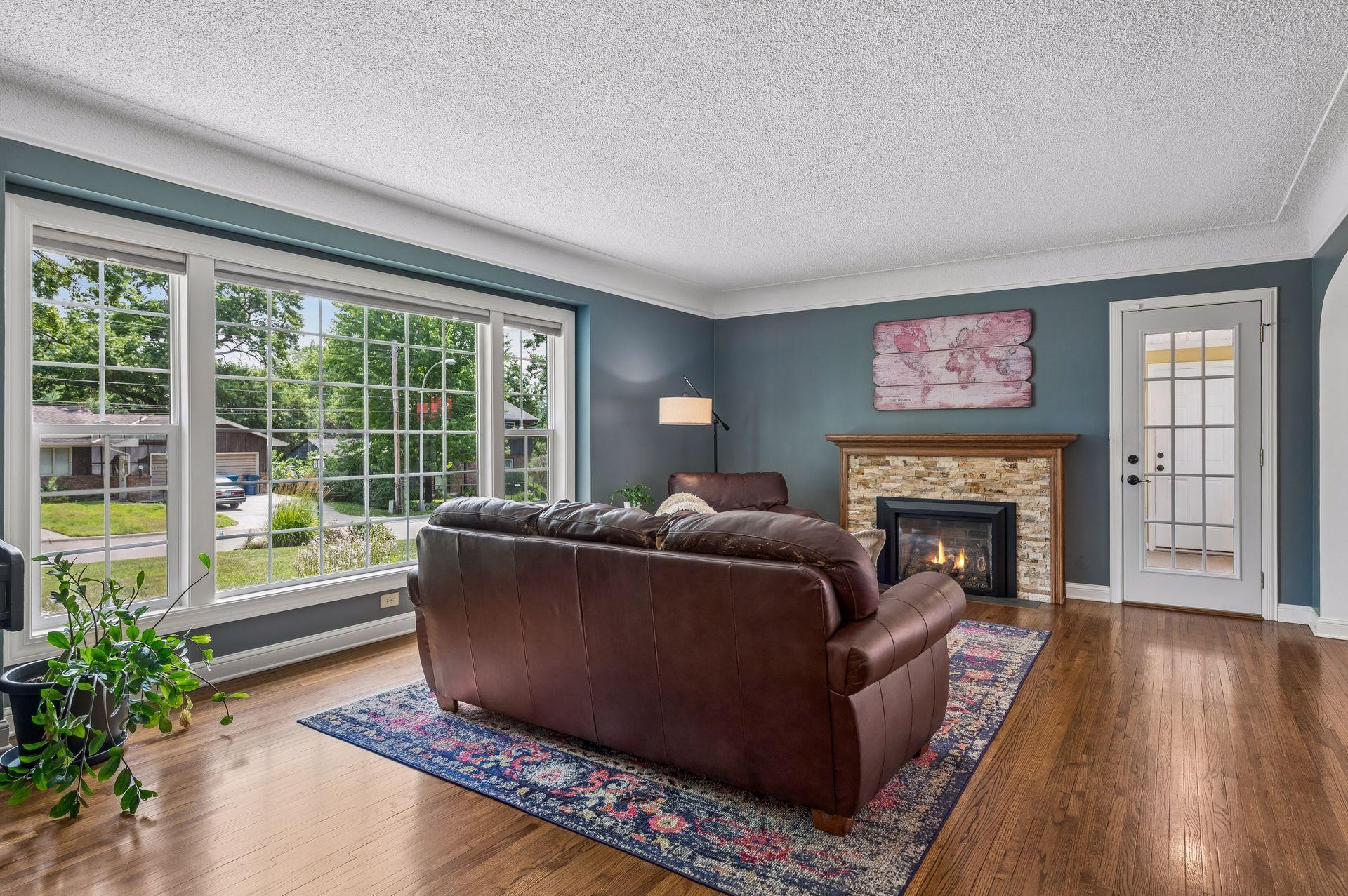 A spacious living room/tv room with natural light pouring in the newer windows throughout the whole house