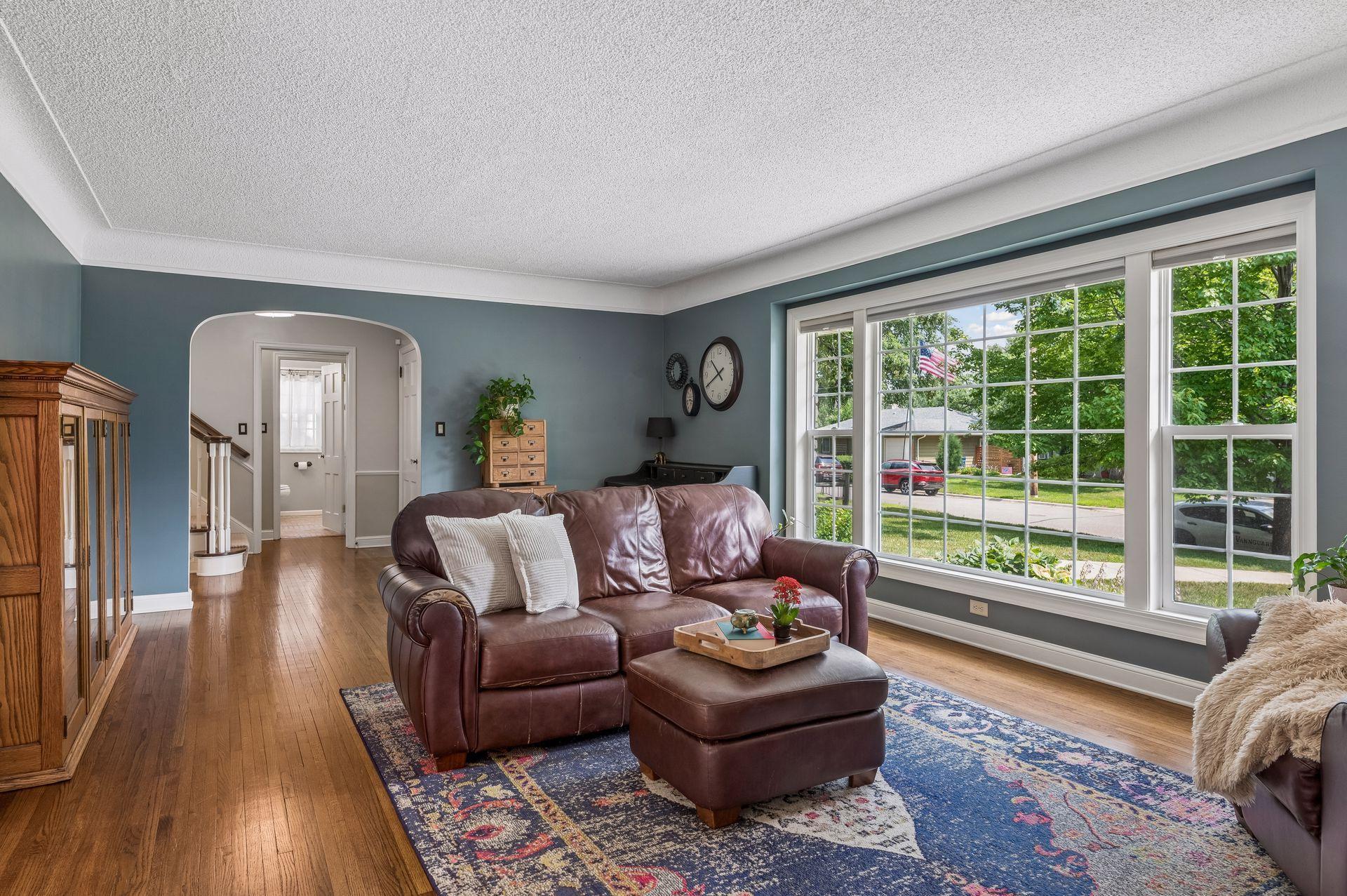 A spacious living room/tv room with natural light pouring in the newer windows throughout the whole house