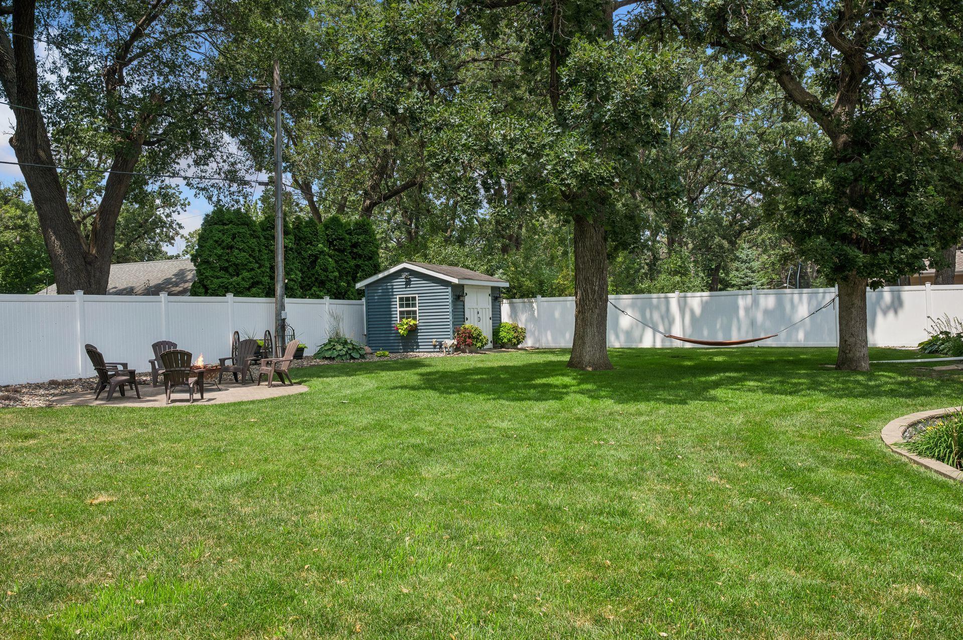 The vinyl privacy fence lines the entire backyard and the storage shed helps keep all the yard extras tidy