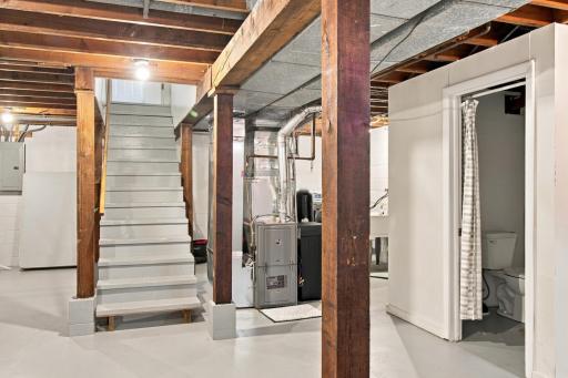 Lower level. Stairway access, mechanicals, and the lower level bath.