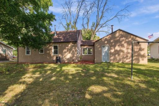 Rear exterior. Rear elevation with the back entry door and open lawn.
