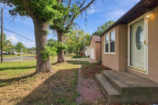 Front entry. Brick paver walkway leading to concrete steps and the front door.