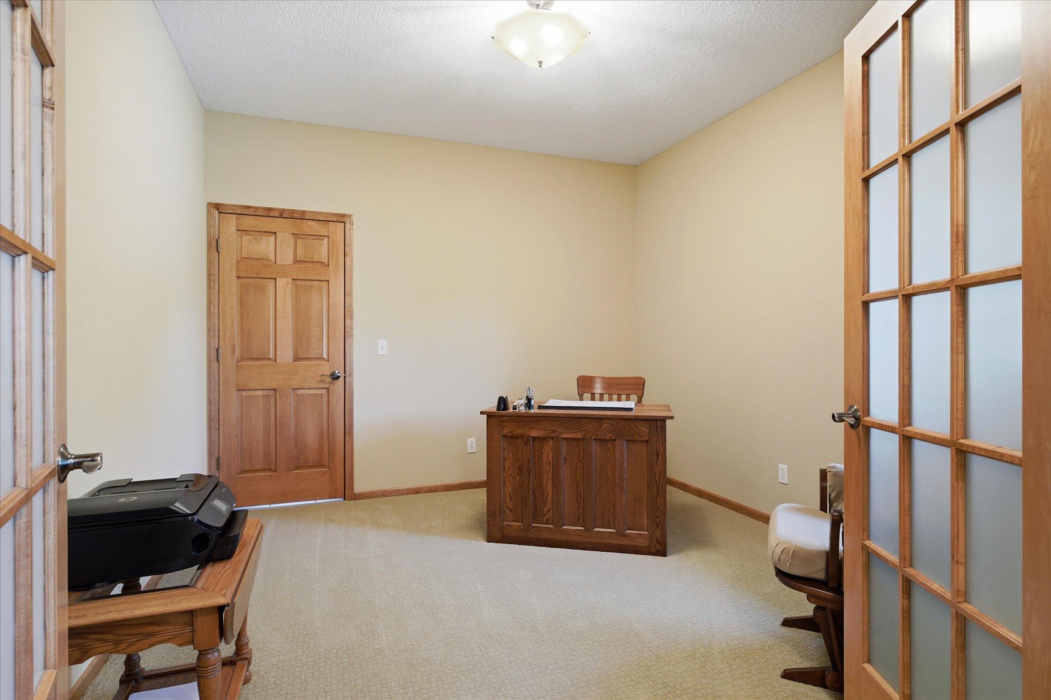 Versatile main-level flex room behind French doors is perfect for a home office, library, or formal dining room to suit your lifestyle.