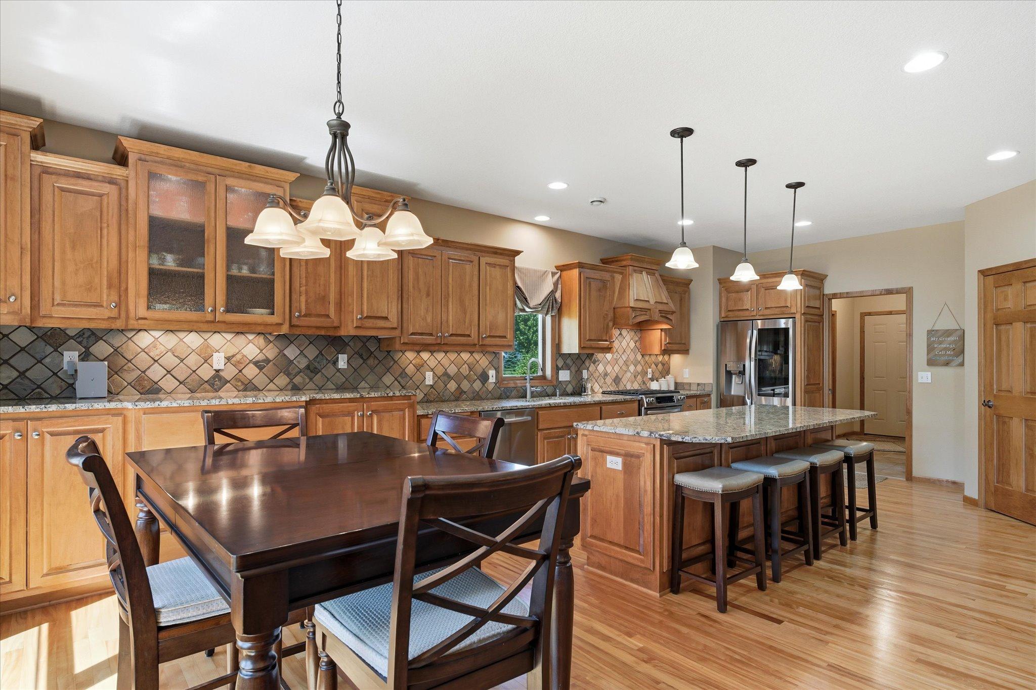 Premium red birch hardwood flooring showcases its distinctive natural grain and rich color, enhancing the home's upscale craftsmanship and open-concept design.