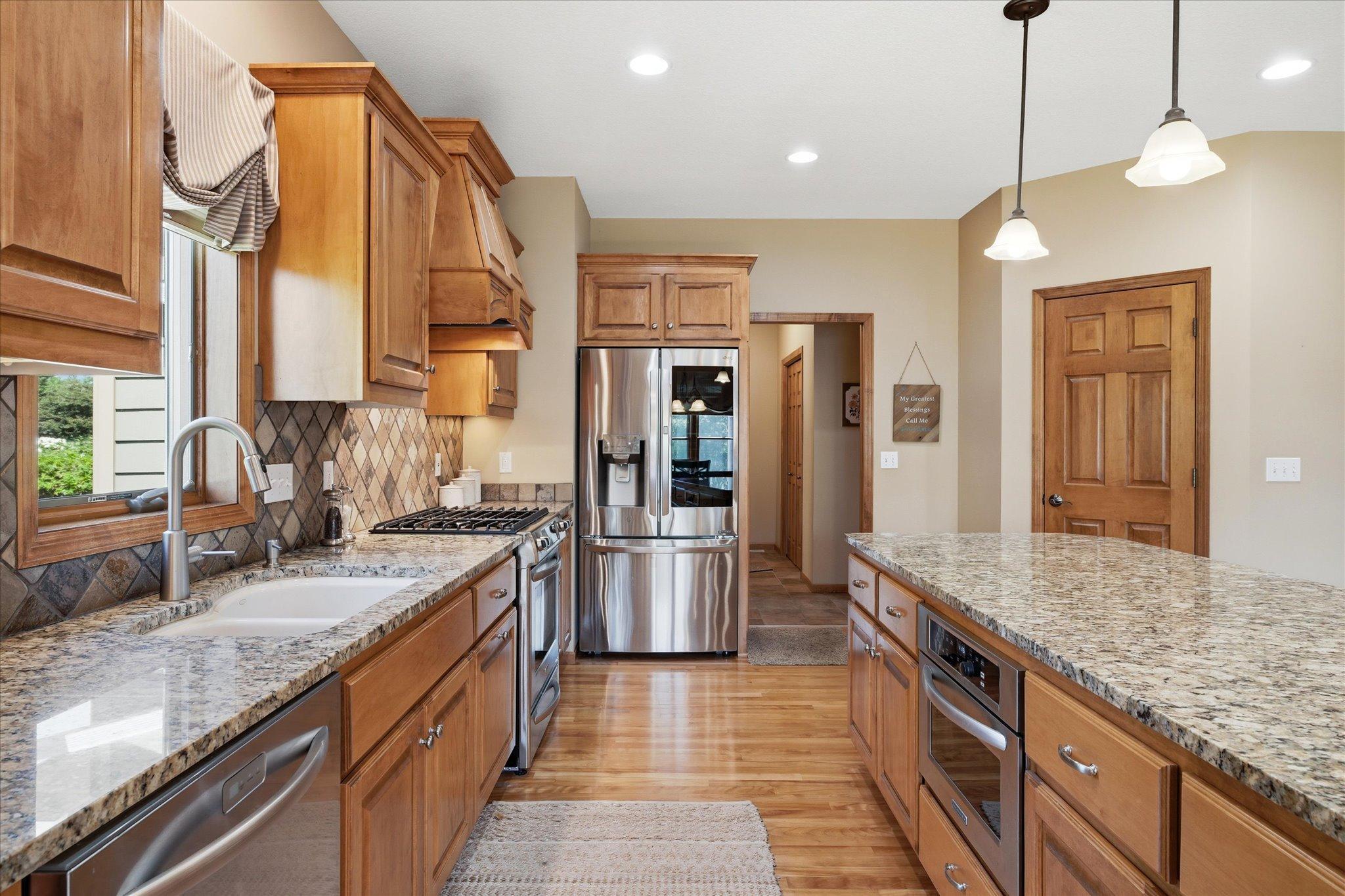 Enjoy cooking with expansive granite countertops, a large center island, stainless steel appliances, and a gas range. Spacious step-in pantry offers an abundance of shelving and storage, making meal prep and organization a breeze.
