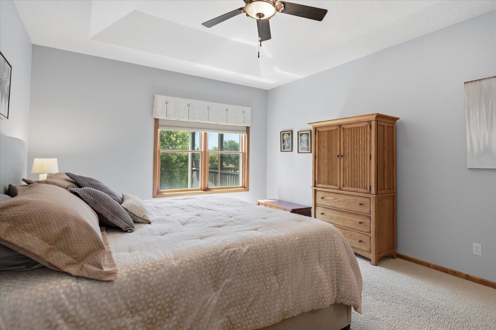 Wake up to serene backyard views from the expansive primary suite.