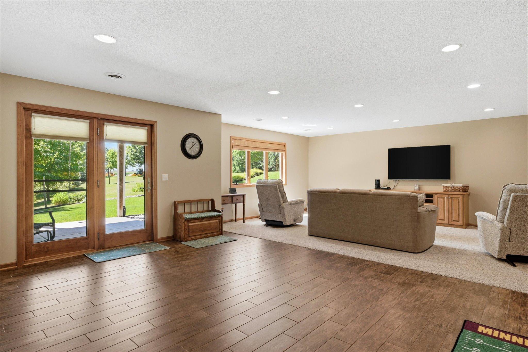Open-concept lower level seamlessly connects the recreation area and family room, providing plenty of room for games, gatherings, or a home gym.