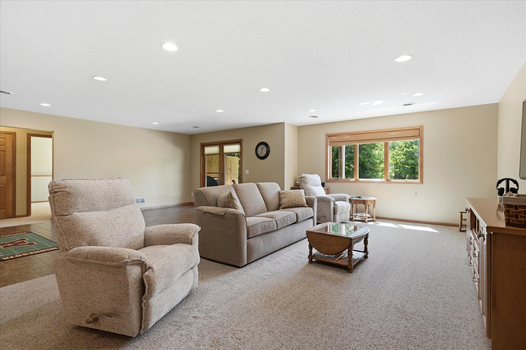 Large picture window fills the family room with natural light while providing peaceful views, creating a bright and inviting place to gather.