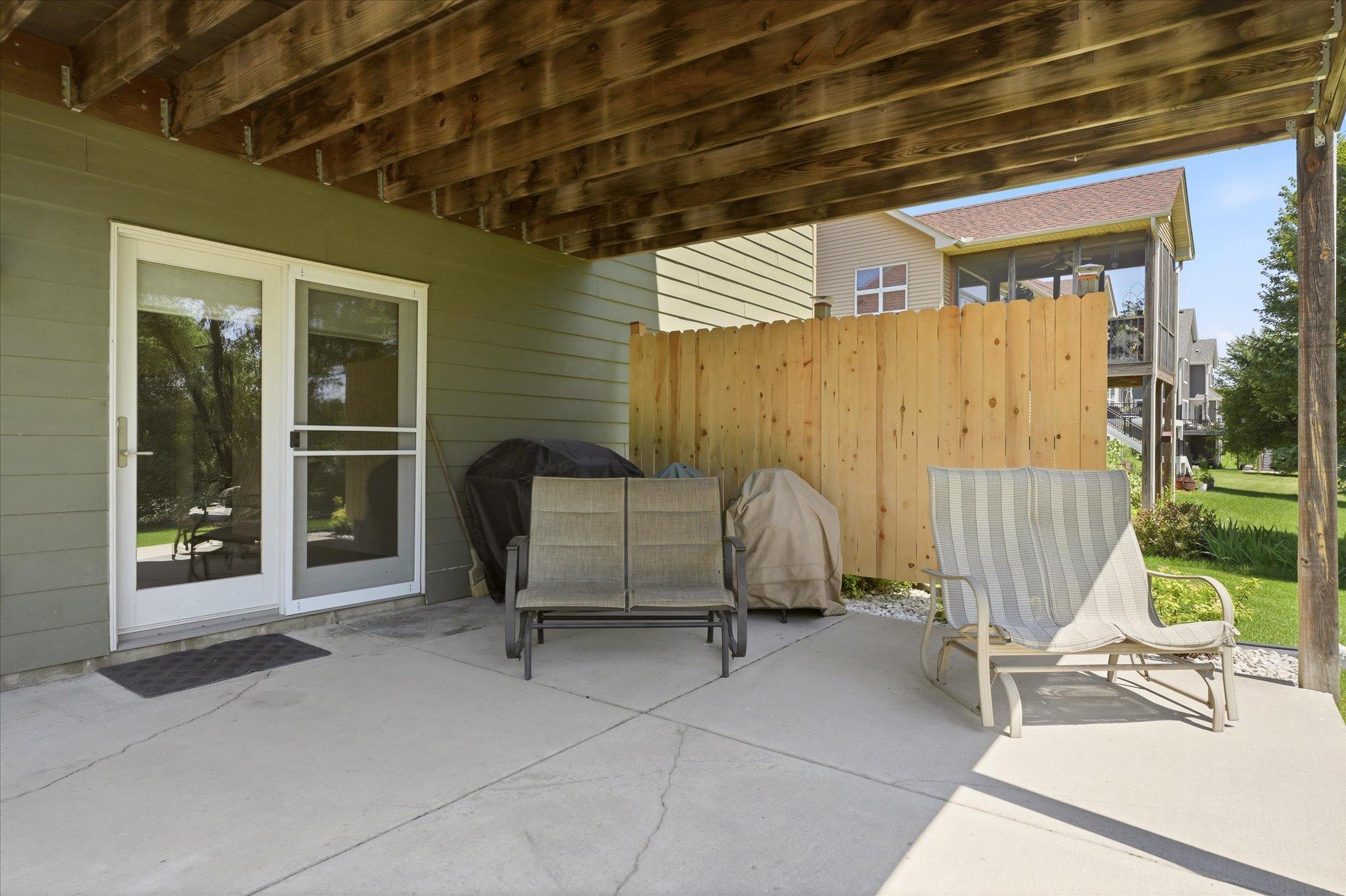 Walkout lower-level patio creates the perfect space for grilling, entertaining, or relaxing in the shade while enjoying the beautifully landscaped backyard.