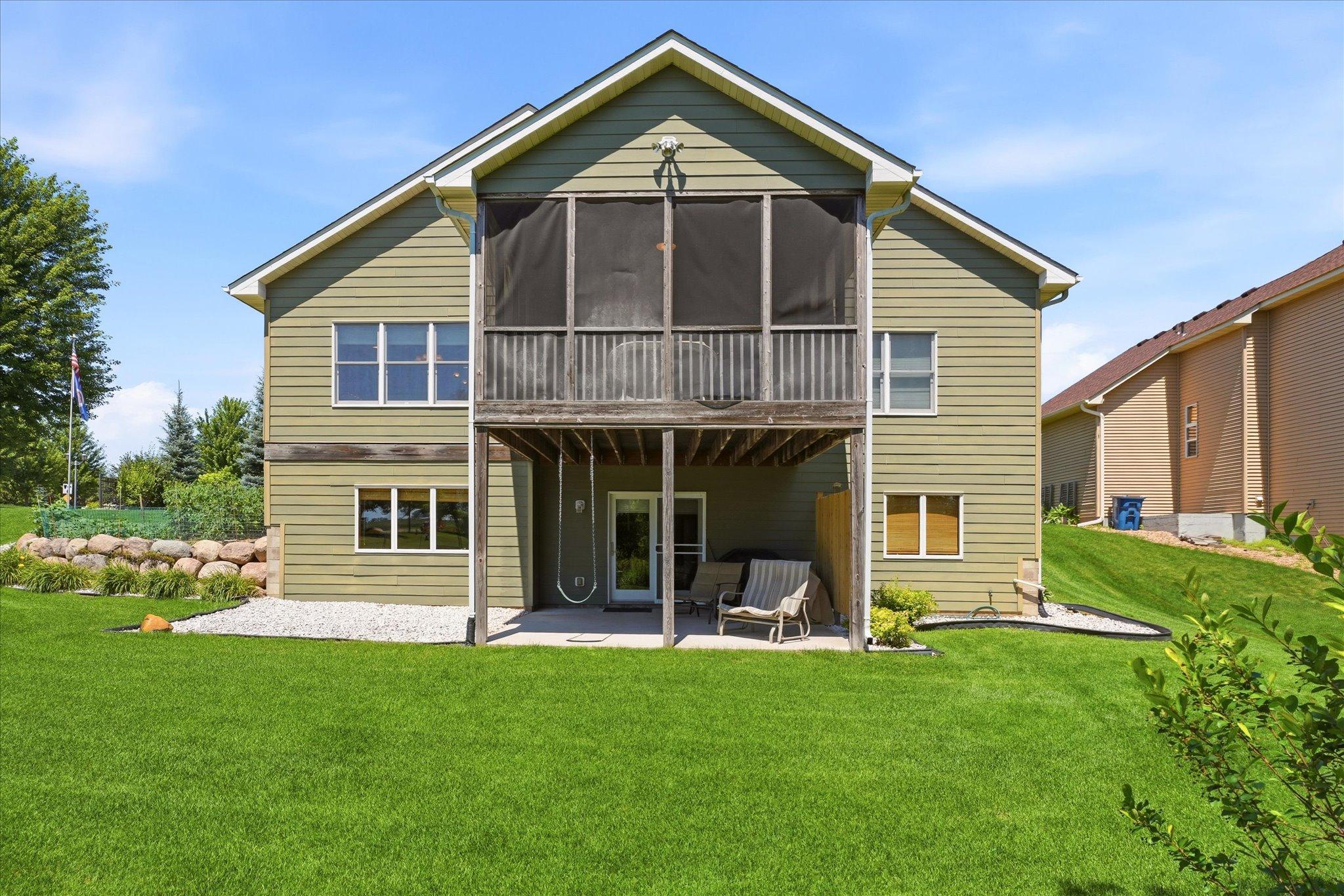 Spacious 3 season porch, a covered walkout patio, and a 16-foot ledger board already installed with a gas line in place, making it easy to add a future deck or outdoor kitchen.