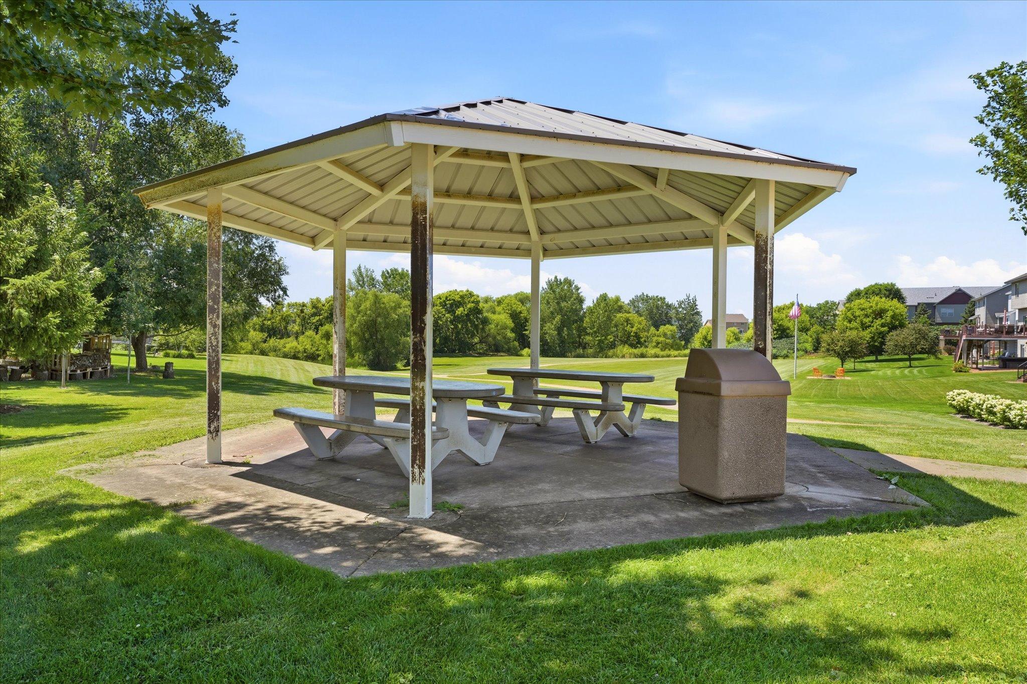 Covered picnic pavilion with tables provides a great space for neighborhood events, or enjoying lunch in the shade.