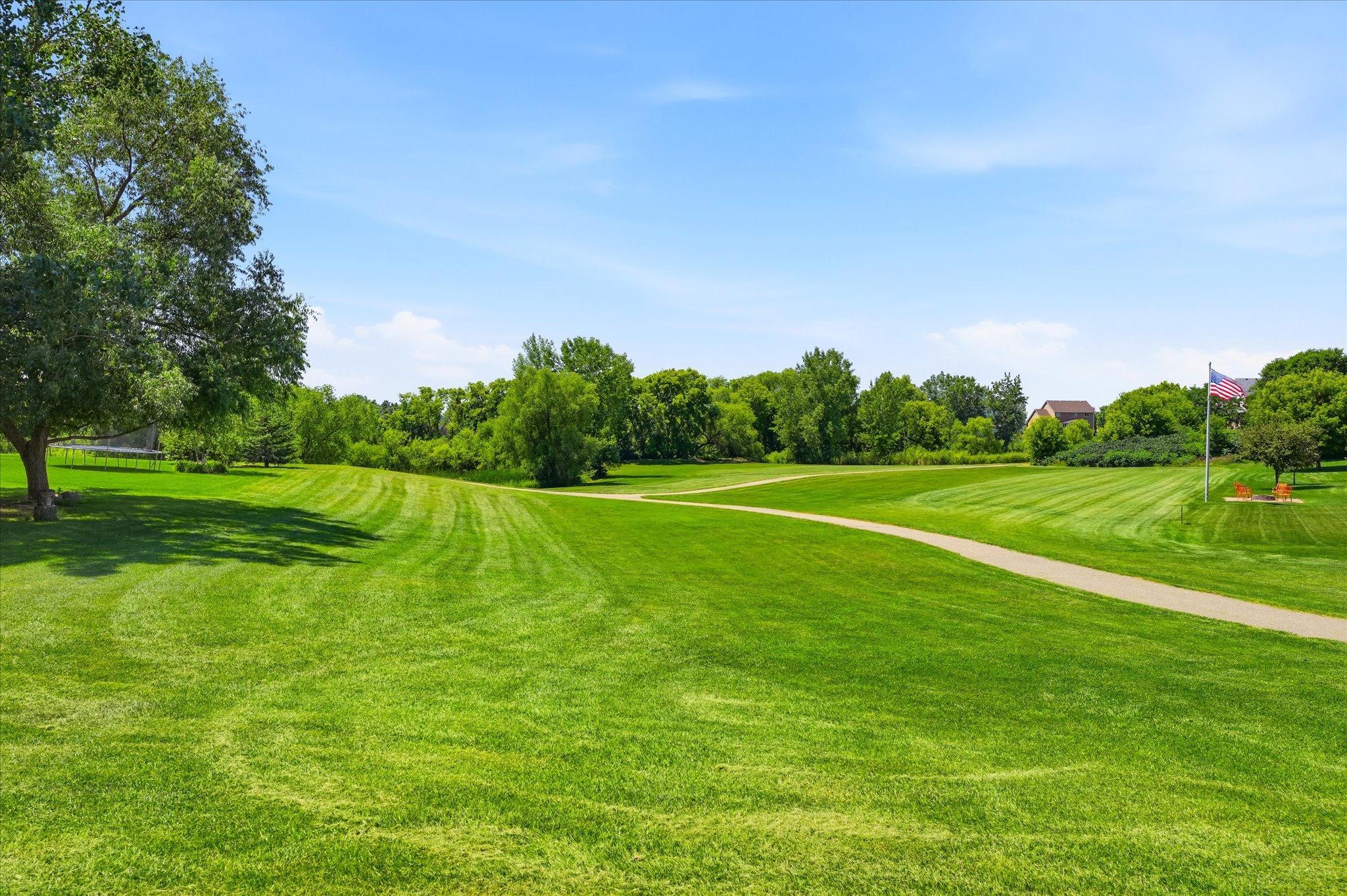 Scenic walking trails wind through beautifully maintained green space, offering peaceful views and plenty of room for walking, jogging, biking, and enjoying the outdoors.