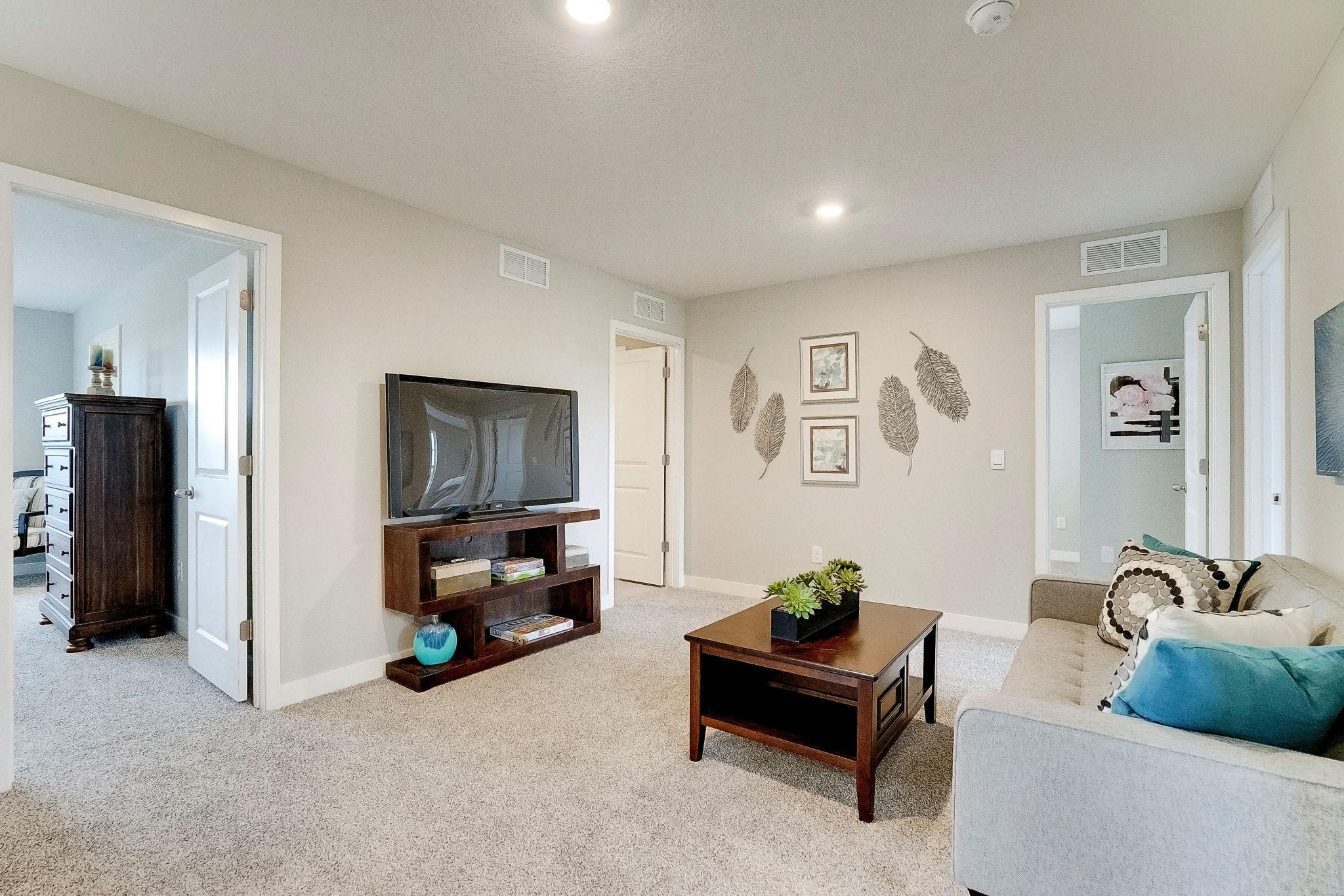 Versatile loft space located in the very center of the upstairs bedrooms. Great for gathering and hanging out! Model picture shown. Colors and finishes may vary.