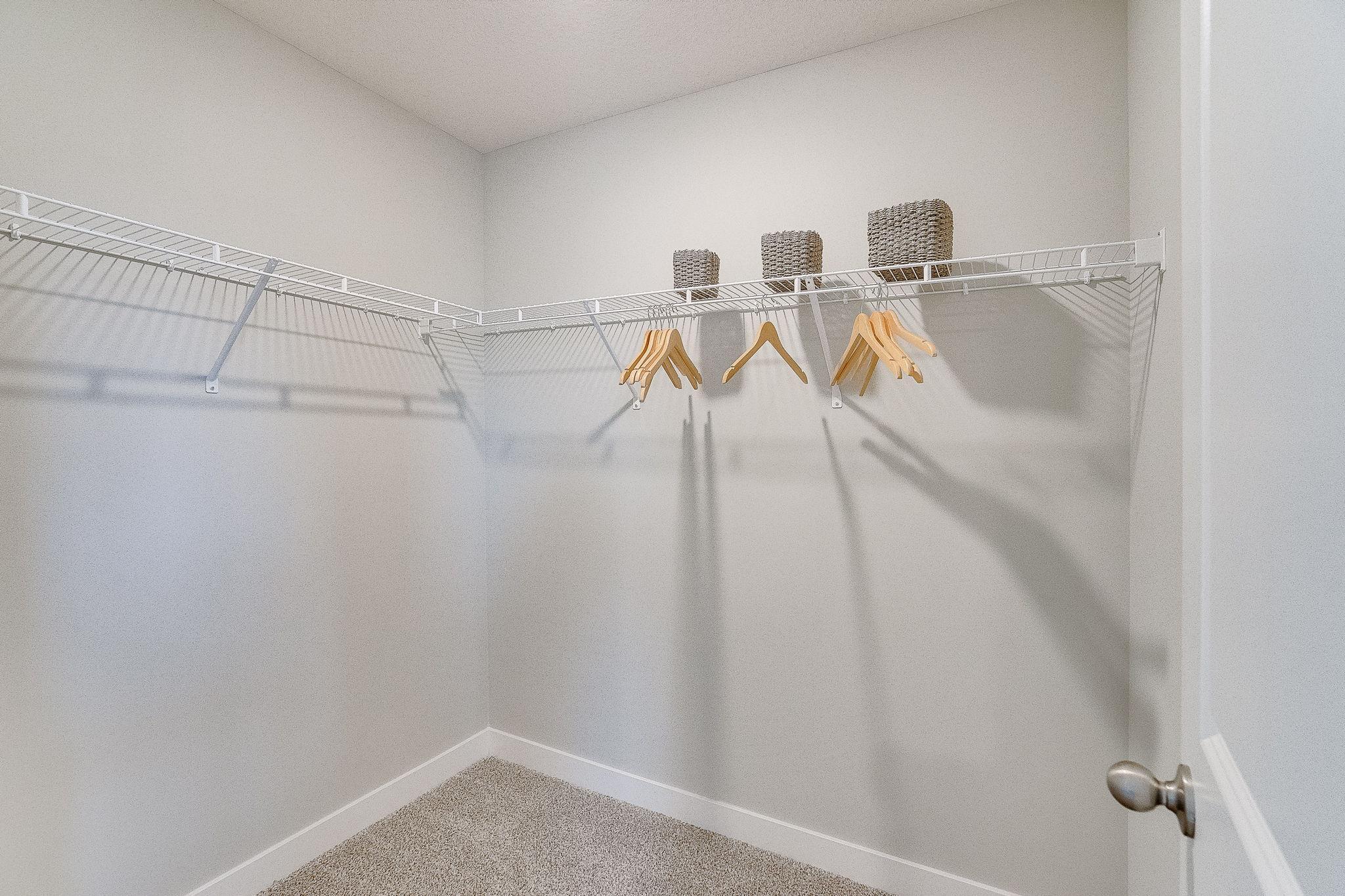Large walk in closets available in bedrooms. Model picture shown. Colors and finishes may vary.