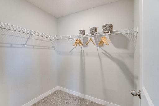 Large walk in closets available in bedrooms. Model picture shown. Colors and finishes may vary.
