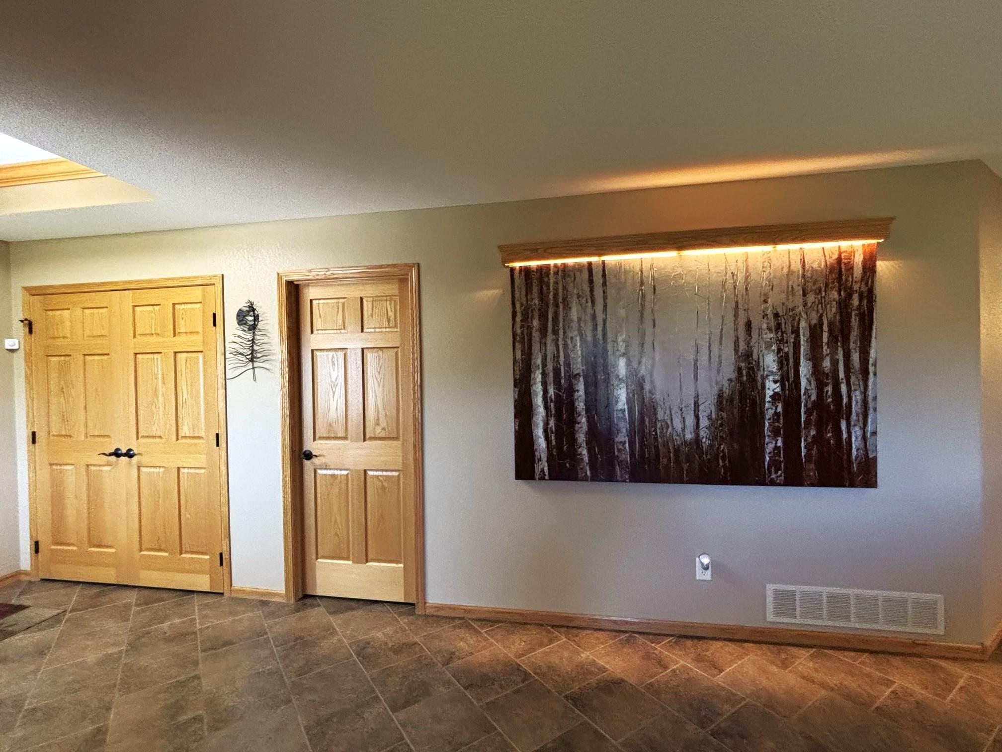 Foyer with lighted wall picture