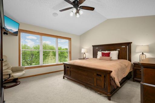 Primary bedroom overlooks the stunning yard.