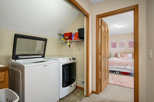 Laundry closet in the hallway in the upper level.