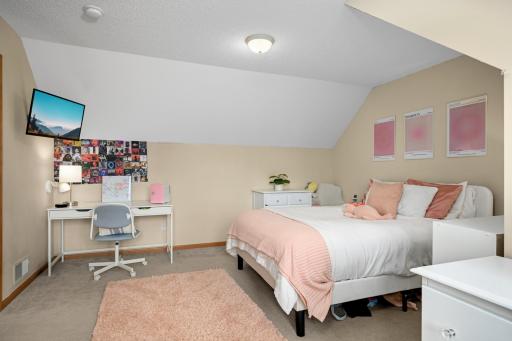One of three additional bedrooms on the upper level that are generous in size.