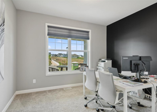 Main Floor Bedroom - Photo is from when the home was staged as a model home & office.