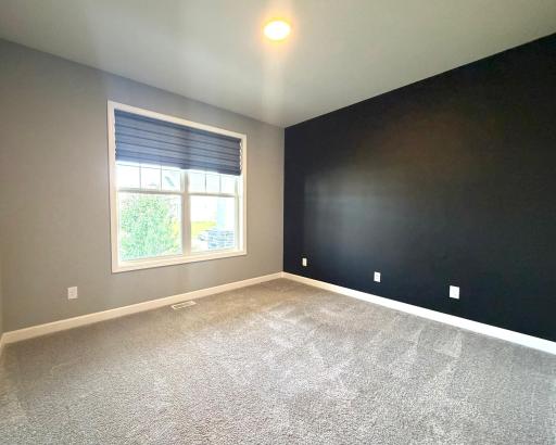 The home offers the 5th bedroom located on the main level! Perfect for a guest bedroom, play room or home office. This room is conveniently located next to a 3/4 bath on the main level. The window covering is included.