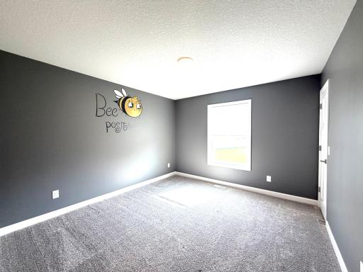 The 4th bedroom offers a large space, fully painted with a decorative accent and large walk in closet.