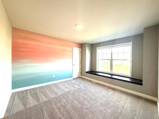 Here is the 2nd of the 4 bdrms located on the upper level! This space is priceless! It offers a large bay window & a amazing seating bench! Perfect place to read a book, take a nap or just gaze outside. There is a walk in closet & blinds included!