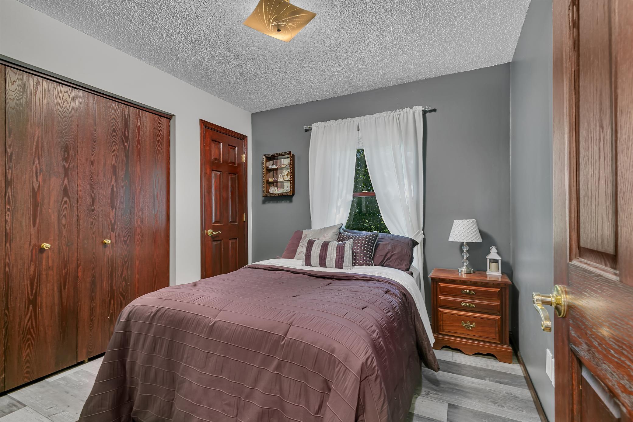 One of four main level bedrooms offering recently updated LVP and six panel doors & two closets.