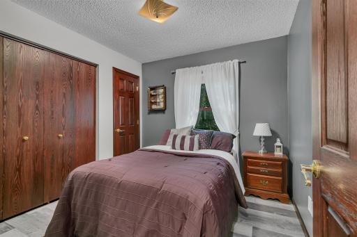 One of four main level bedrooms offering recently updated LVP and six panel doors & two closets.