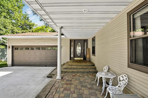 Welcoming covered entry is wonderful to sit and enjoy nature. This paver patio is a great addition to this already fantastic lake home. Oh, and the concrete driveway is next too new!