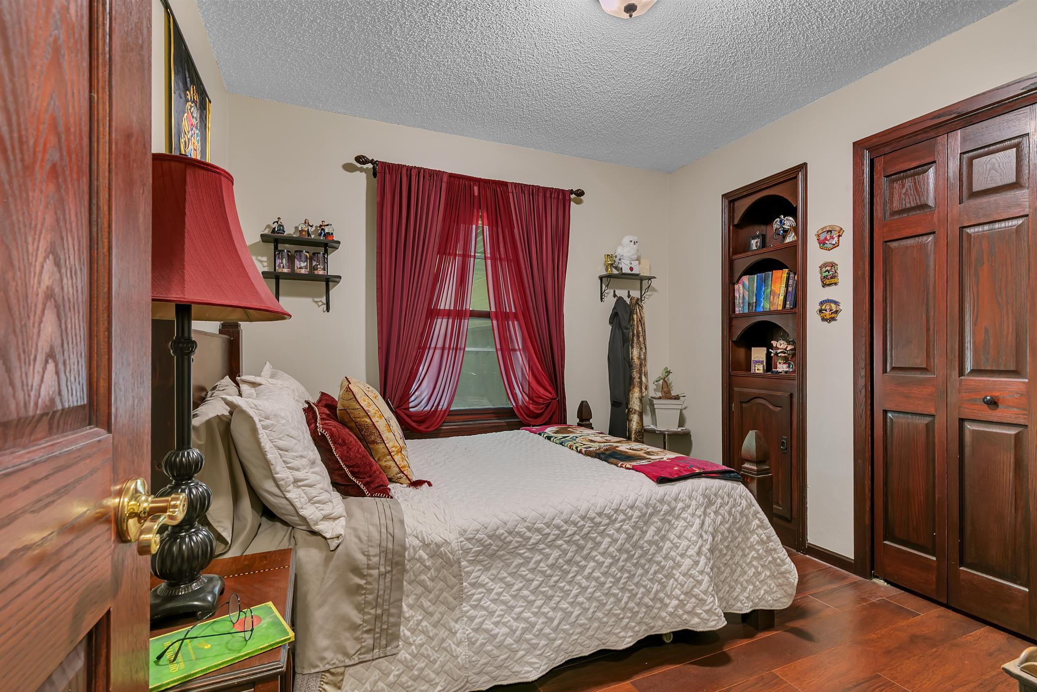 Second of four main level bedrooms offering a large closet, built in and updated flooring.
