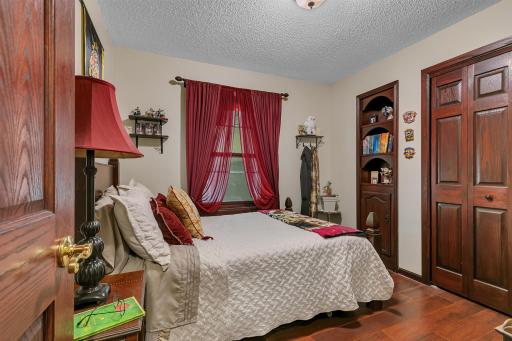 Second of four main level bedrooms offering a large closet, built in and updated flooring.