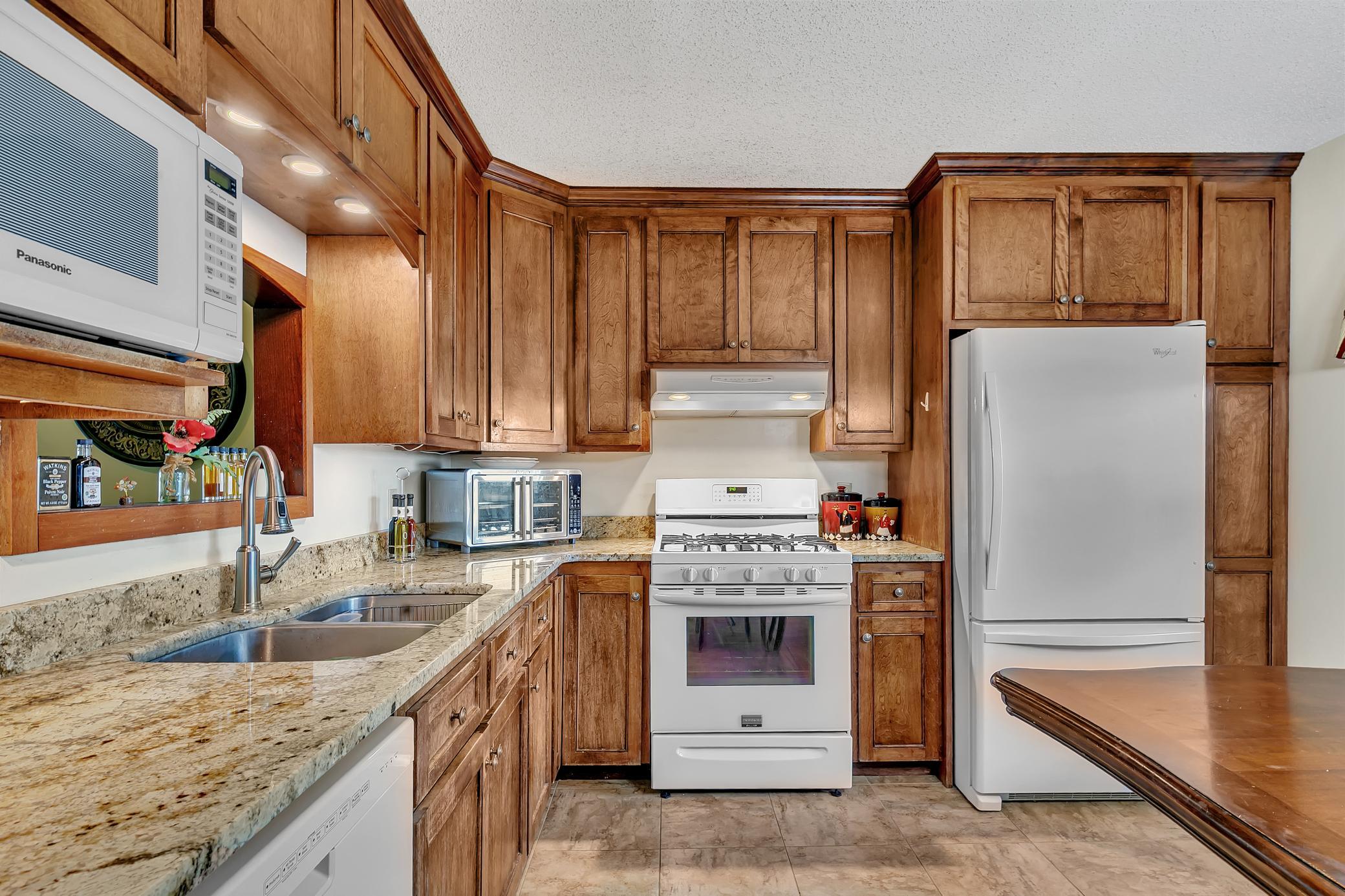 Another view of the kitchen and granite counter tops. This home is move-in ready for you to enjoy!