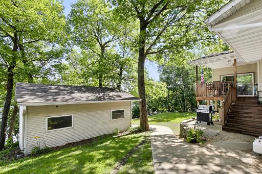 You will find some great concrete work around the property. Sidewalk leading to the spacious and open back yard. Lake side one car garage is great for all your lake toy storage.