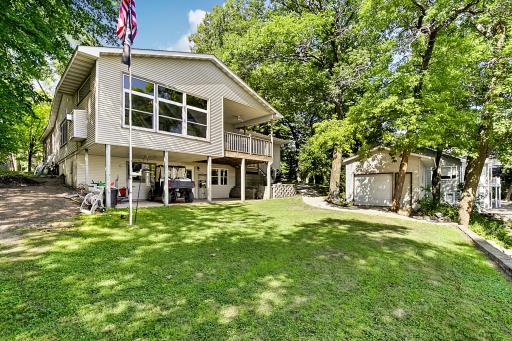 Another view of the lakeside of the home and lakeside garage. The is a one owner home that has been well cared for throughout the years. Ready to make it yours?