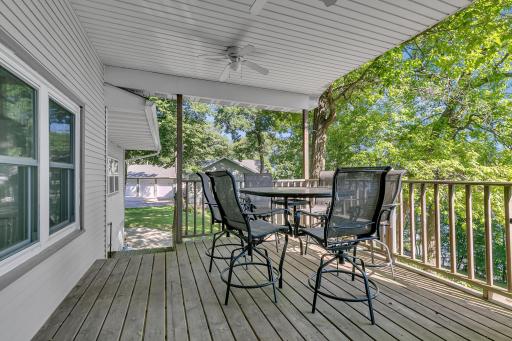 Just off of the porch and kitchen area is the covered deck offering a great space to enjoy long summer days along with lake views while the fans help to keep things cool.
