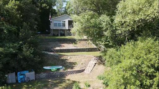 View of the terraced backyard. Imagine what you could do with some perennials and maybe even set up eating at each level? Possibilities are endless!