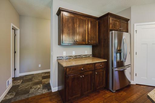 Beyond the kitchen lies a huge mud room and half bathroom.