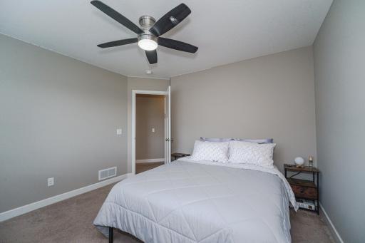 This is one of four upper level bedrooms. They have ceiling fans and deep closets.