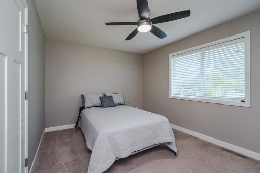 This is one of four upper level bedrooms. They have ceiling fans and deep closets.