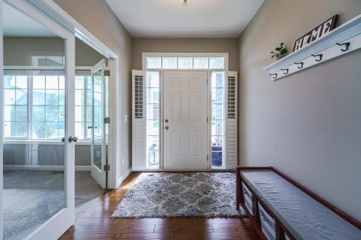 The front entry is bright with an overhead transom and full-view sidelight windows. Glass French doors in the den/study also allow light to enter the foyer.