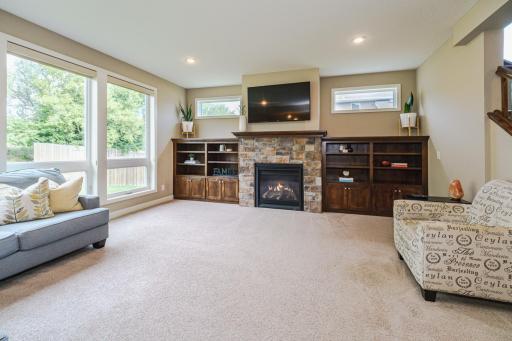 The family room features 9-foot ceilings, a stone (gas) fireplace flanked by built-ins, recessed lighting and oversized windows. There is a tech tube behind the wall.
