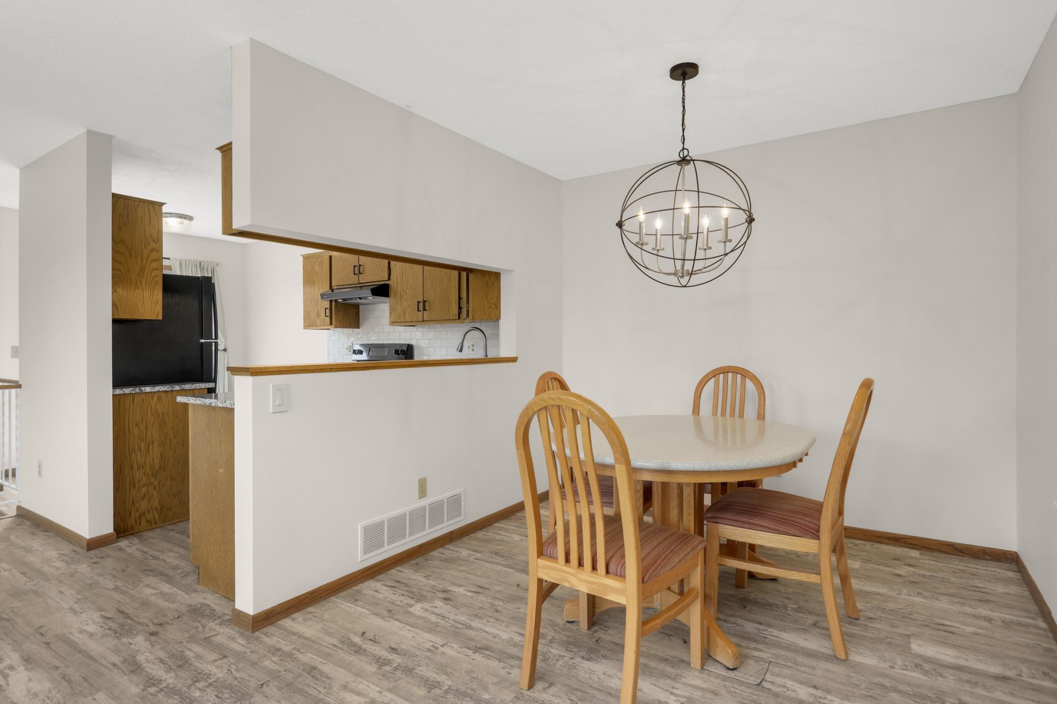 The dining area is well defined and large enough for a full size table. The light fixture is the perfect statement piece to compliment the modern relaxed style of the open concept design.