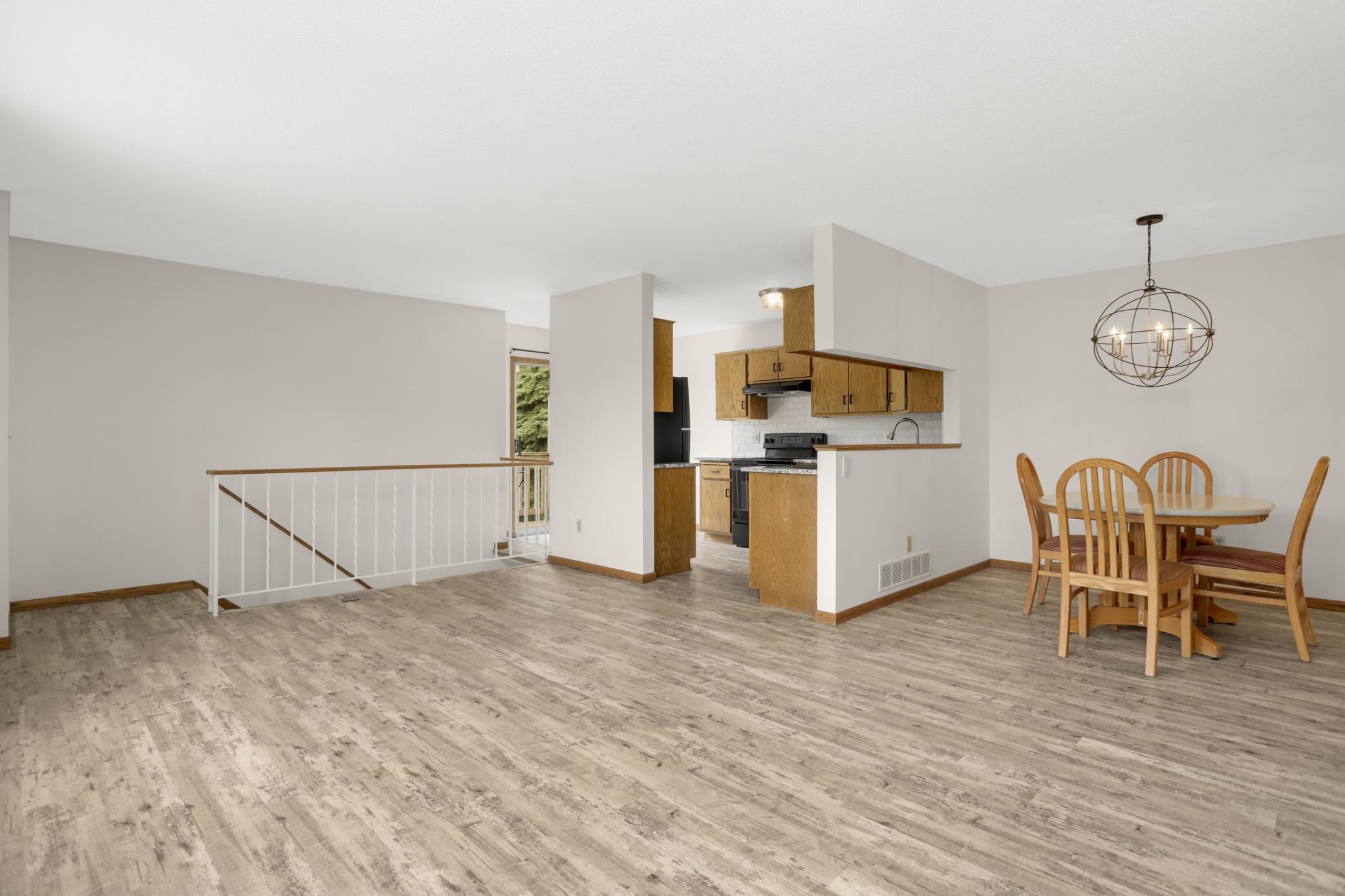 The open concept floor plan provides versatility for the living room arrangement and a defined area for dining.
