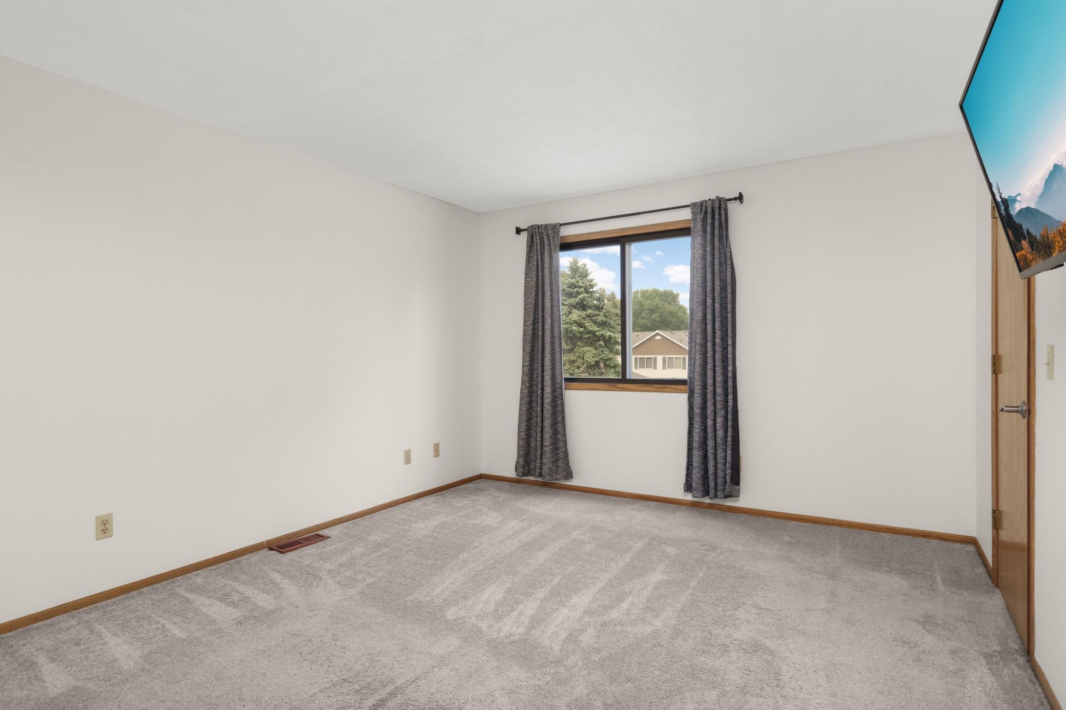 Another view of the primary bedroom. The closet is on the right.