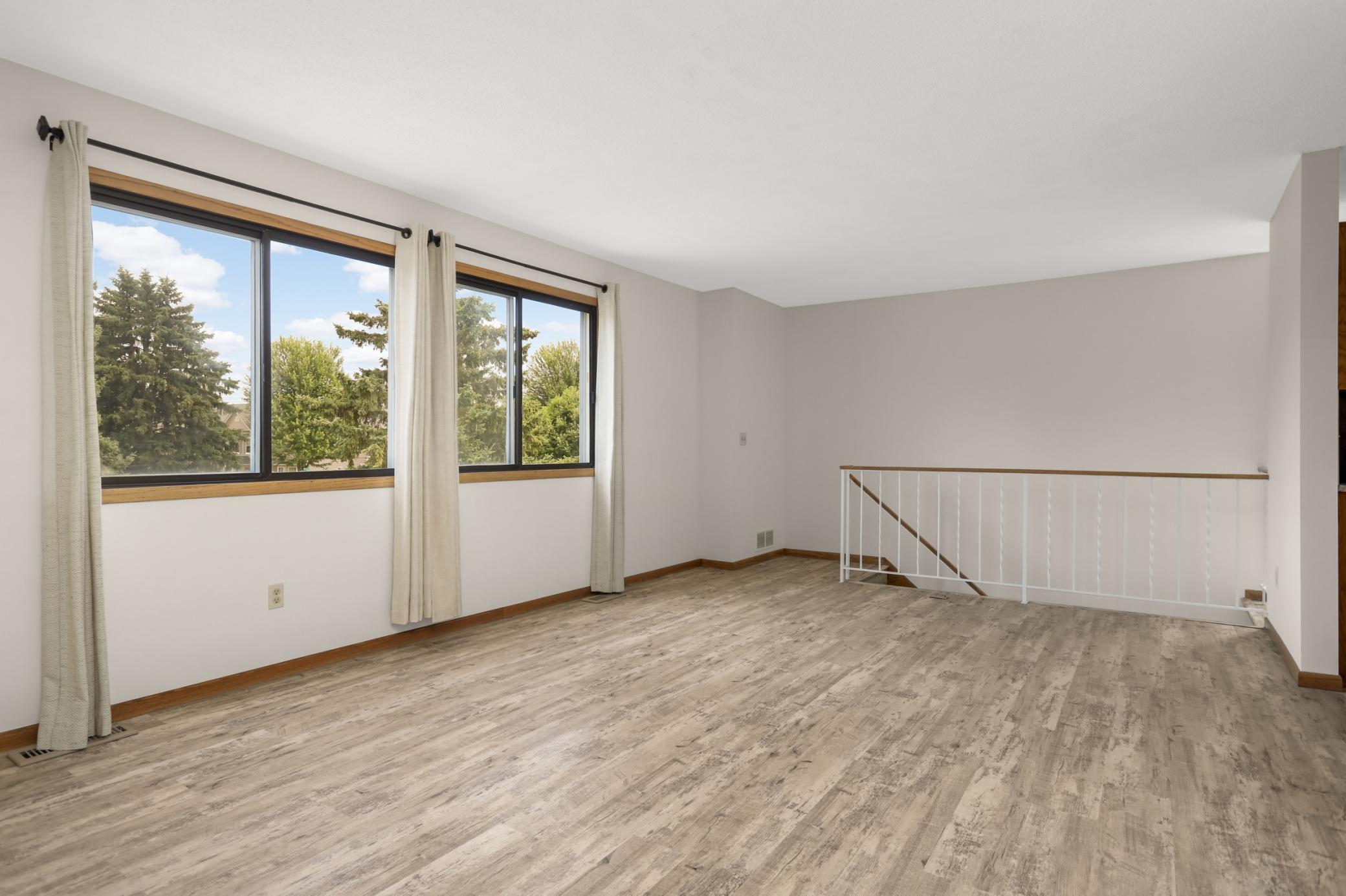 The entire home is freshly painted. The steps lead to the front entry door on ground level. The entry has a coat closet. The garage access door is also located in the entry space.