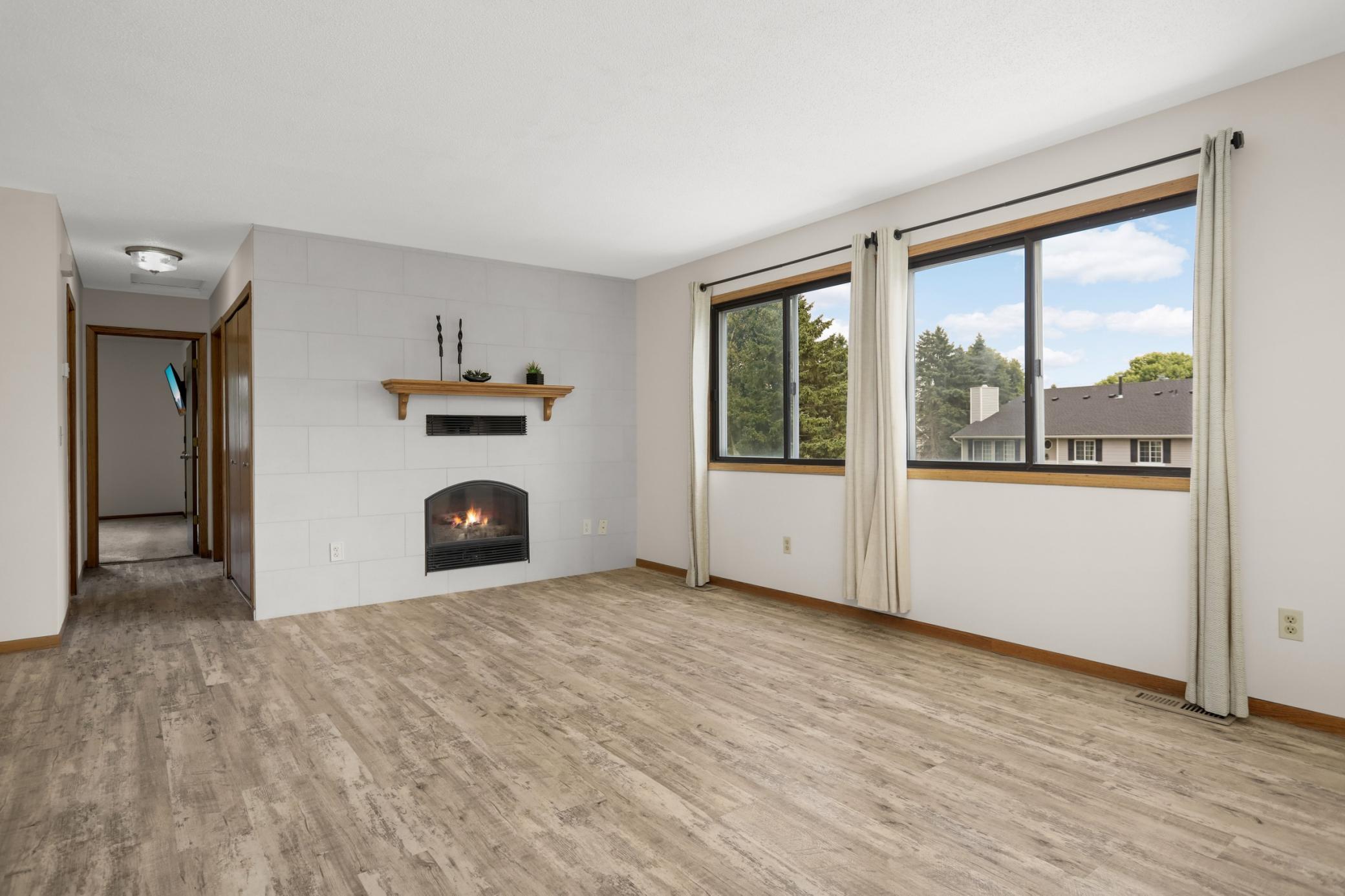 The wall of windows brings in natural light and a cheery inviting atmosphere. The bedrooms and bathroom are located down the hall.