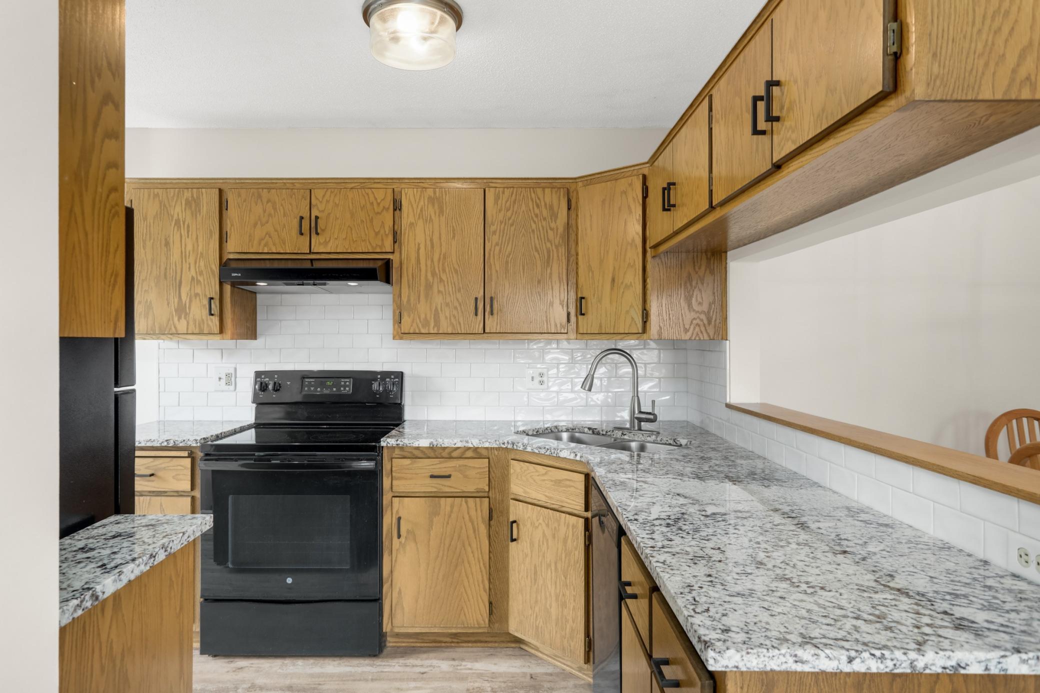 The kitchen has plenty of storage space and counter space for food prep.
